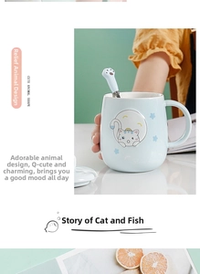 Detail view of light blue ceramic cat mug with embossed kitten and cat paw spoon