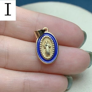 Macro view of a gold-rimmed blue enamel Jesus pendant with detailed religious relief
