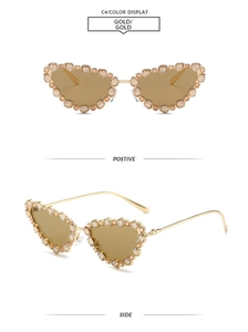 Close-up of gold cat eye sunglasses with luxury rhinestone embellishments on the metal frame