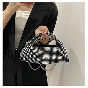 Detailed view of women's sparkling rhinestone evening bag with elegant metal chain strap