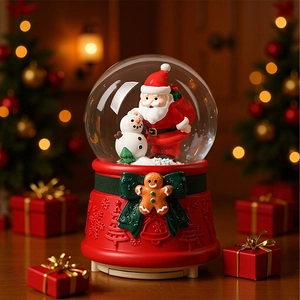 Christmas snow globe with Santa and Snowman figures on a red gingerbread man base