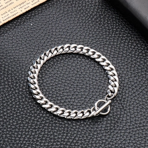 Macro shot of silver stainless steel Cuban chain bracelet with OT toggle clasp on leather