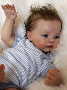 Close-up of 49cm reborn baby doll with realistic 3D skin texture and vivid blue eyes