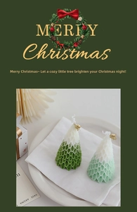 Close-up of handmade Christmas tree candles with snow-covered tips and golden bells