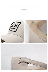 Detail of khaki baseball cap featuring embroidered XX patch and metal adjustable buckle