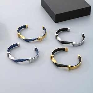 Close-up of twisted titanium steel C-shaped bracelets with woven leather and crystals