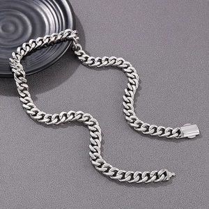 Detail of silver Cuban link necklace showing polished finish and sturdy clasp closure