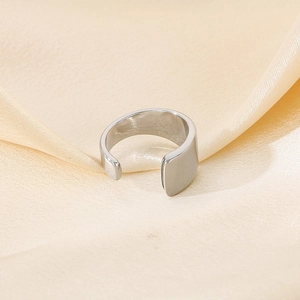Minimalist wide open band stainless steel ring in silver finish on silk fabric