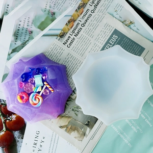 Detail of ten-sided petal silicone mold with purple resin plate and sweet candy charms