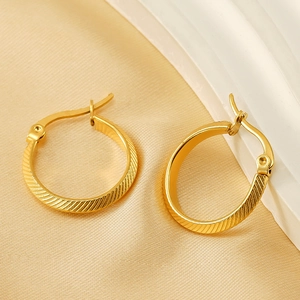 Minimalist striped gold plated stainless steel hoop earrings shown from a 45-degree angle