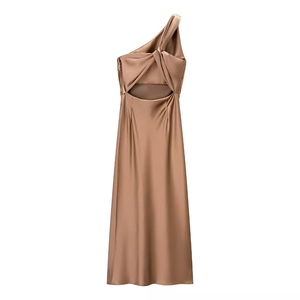 Detail of champagne gold satin dress showing silk texture and asymmetric shoulder design