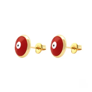 Detailed macro view of 18K gold-plated red evil eye stud earrings with enamel finish