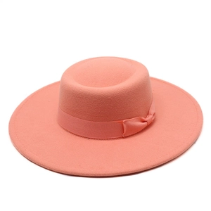 Detail view of pink wool fedora hat with flat brim and decorative silk ribbon bow