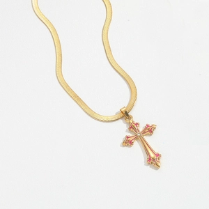 Detailed view of golden snake chain with pink enamel cross pendant and central zircon
