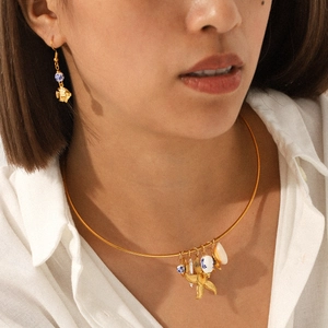 Detail of nautical necklace set with blue porcelain beads, starfish, and shell charms