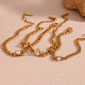 Detailed close-up of 18K gold plated chains with round and pear-shaped zircon stones