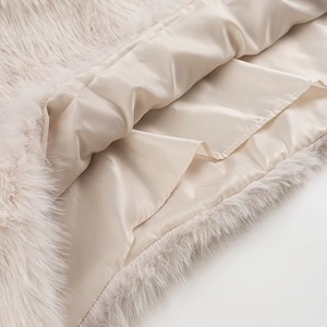 Detailed macro shot of champagne faux fur texture and smooth silk satin lining finish