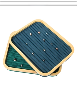 Detailed close-up of dark green velvet slots in a bamboo wooden ring jewelry display tray