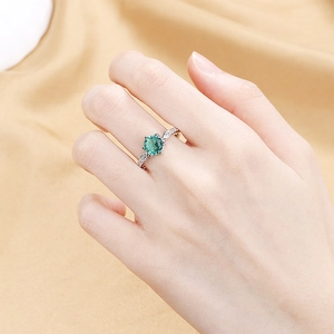 Elegant silver open ring with a vibrant green teardrop gemstone and side accents