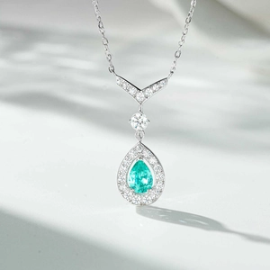 Macro view of S925 silver necklace with teardrop blue gemstone and sparkling white zircons
