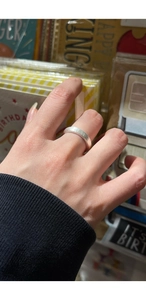 Close-up of minimalist S925 sterling silver frosted ring with a brushed texture finish