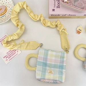 Detail of adjustable cloud pleated strap and yellow handle on plaid water bottle bag