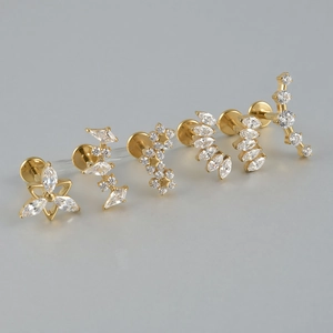 Golden F136 titanium labret studs set with marquise zircon flowers and star shapes