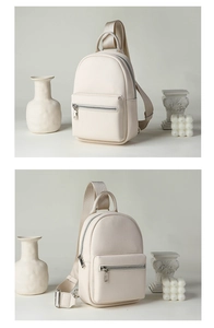 Detail of cream lychee texture crossbody bag with silver zippers and minimalist styling