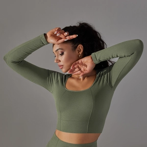 Detail of dark green honeycomb knit texture on a tight yoga long sleeve shirt