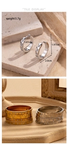 Detail of silver rhinestone hoop earrings and layered metal bangles with weight and size data