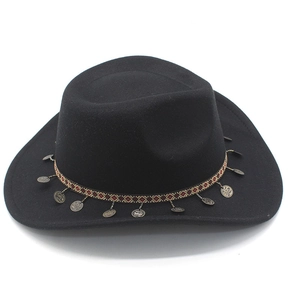 Close-up of black felt cowboy hat featuring ethnic woven band and metallic coin pendants