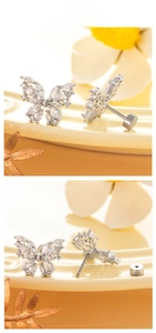 Macro shot of silver butterfly stud earrings with zircon inlay and screw flat back