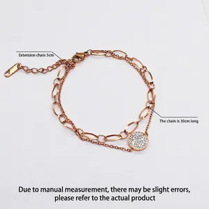 Double-layered rose gold stainless steel bracelet with a crystal pendant and lobster clasp