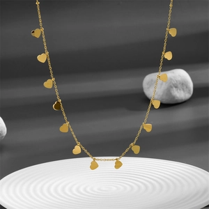 Minimalist gold stainless steel choker necklace featuring multiple heart pendants on a base