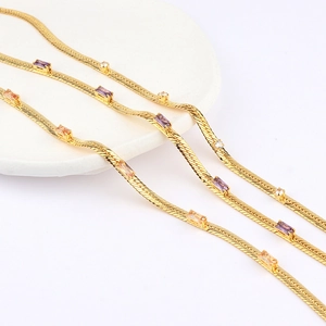 Detail of 18k gold plated flat snake chain with purple and orange zircon accents