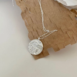 925 silver compass map pendant necklace with textured globe detail on honeycomb paper