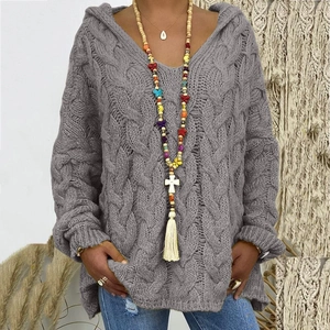 Detail of grey cable knit hoodie with thick texture and V-neckline for a cozy winter look
