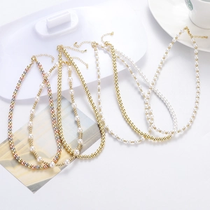 Close-up of beaded necklaces with gold, silver, and pearls featuring lobster clasps
