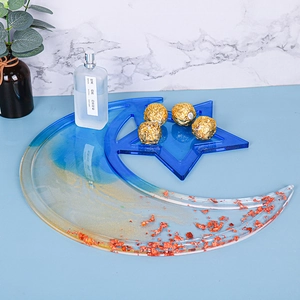 Macro view of moon and star resin trays featuring blue gradient and gold foil flakes