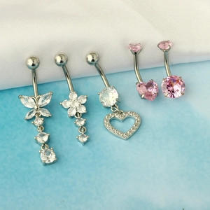 Detail of five silver belly rings with pink heart and butterfly zircon pendants