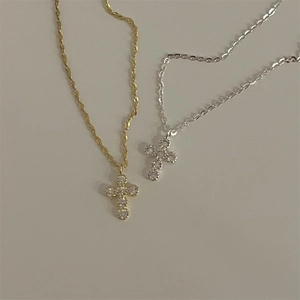 Detail of 925 sterling silver cross pendants in gold and silver with cubic zirconia stones