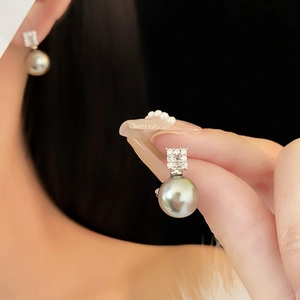 Detail of Tahitian grey pearl earring with cubic zirconia studs shown on ear