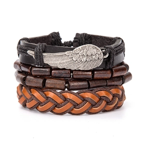 Detail of multilayer leather bracelet featuring silver wing charm and brown wooden beads