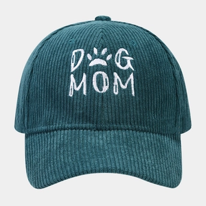 Detailed view of DOG MOM embroidery on dark teal corduroy texture baseball cap