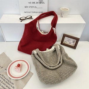 Detailed close-up of plush fleece tote bags in dark red and grey with button fasteners