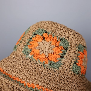 Handmade crochet straw sun hat with floral pattern for summer beach vacations