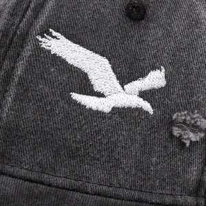 Vintage dark gray truck hat featuring white eagle embroidery and distressed details