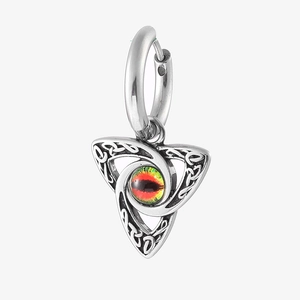 Macro view of Celtic knot triangle earring with a red and yellow evil eye bead
