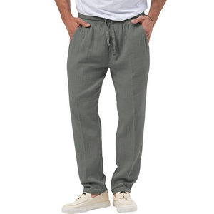 Detail of grey men's linen trousers with elastic drawstring waist and textured fabric