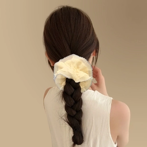 French style double-layer lace scrunchie in apricot with blue trim on a braided hairstyle